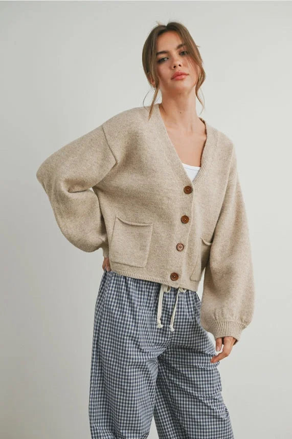 Loose-fitting beige long sleeve cardigan with neck cuff button-up design and front pockets