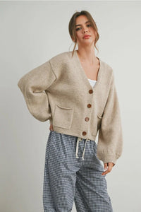 Loose-fitting beige long sleeve cardigan with neck cuff button-up design and front pockets