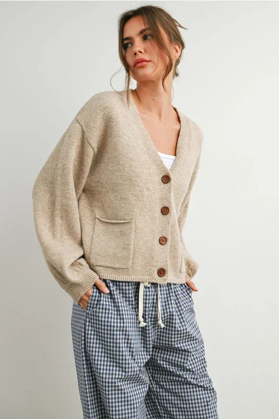 Beige long sleeve cardigan with neck cuff and button-up front pockets