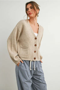 Beige long sleeve cardigan with neck cuff and button-up front pockets
