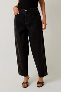 Black denim balloon pants with leopard print piping and contrast stitching for stylish appeal