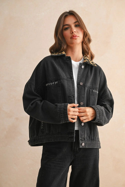Black oversized denim jacket with leopard print collar and white stitching details