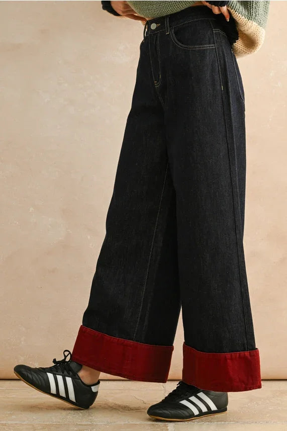 Black and red wide leg contrasted cuffed pants with rolled cuffs and Adidas sneakers