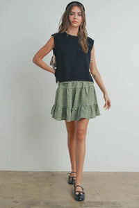 Mock neck sleeveless sweater in black top with green gingham ruffle skirt