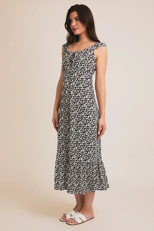 Black and white floral print midi dress with tie cap sleeves and a sweetheart neckline