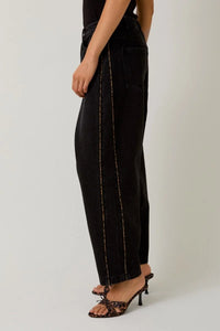 Black wide-leg jeans with leopard print piping and contrast stitching for a relaxed fit