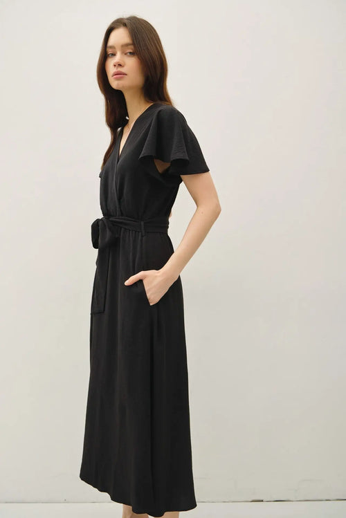 Black wrap dress with ruffle cap sleeves and V neck with tie waist, midi length