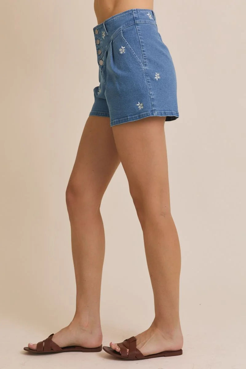 Blue denim shorts with floral embroidered pleated design for stylish casual wear