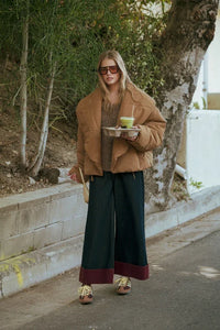 Brown suede jacket with wide-leg contrasted cuffed pants and sunglasses for a stylish look