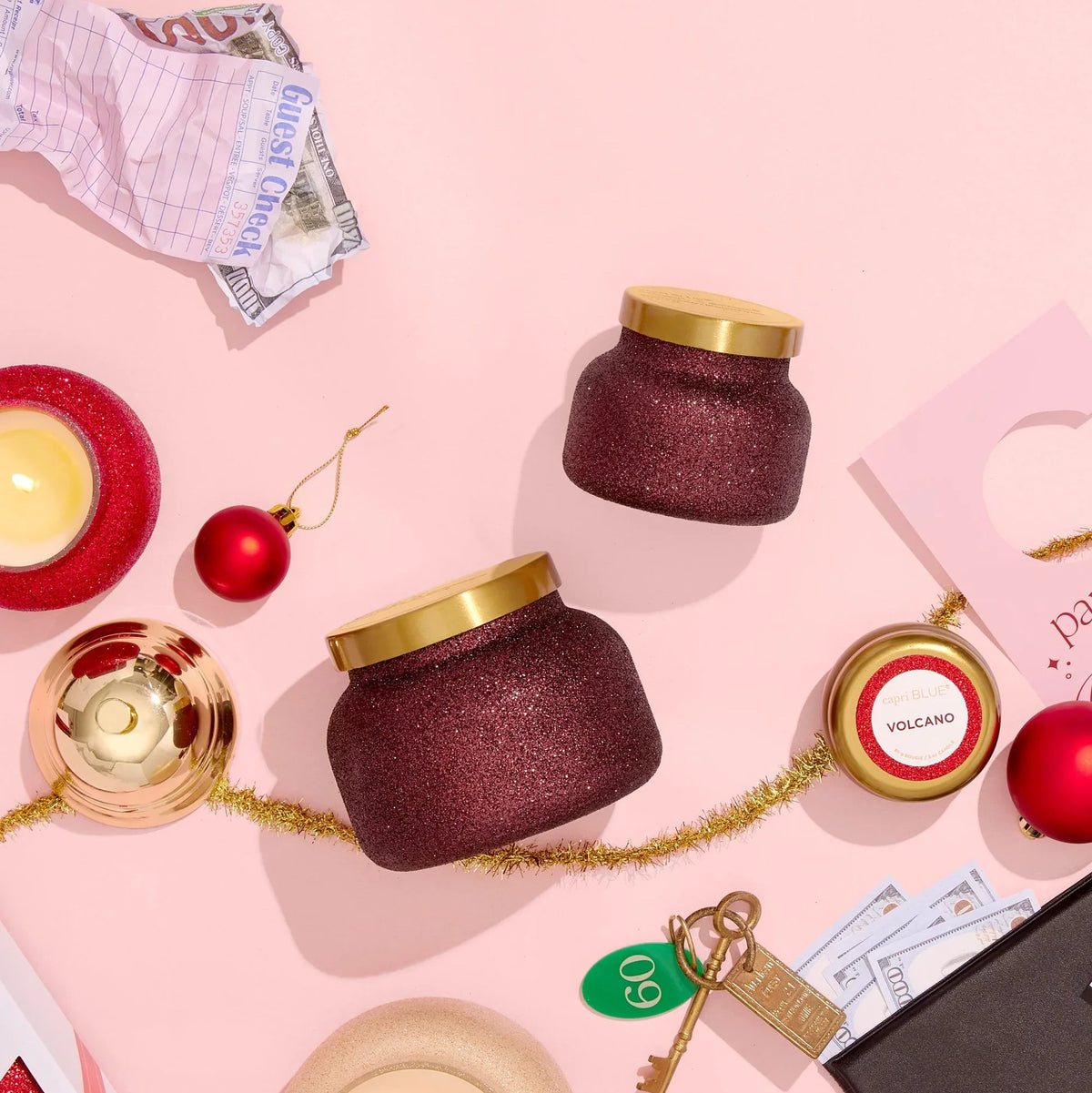 Burgundy glittery Tinsel & Spice Glam Petite Candle jar with gold lid and red ornaments
