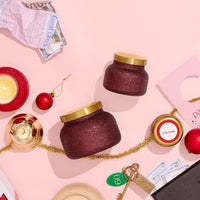 Burgundy glittery Tinsel & Spice Glam Petite Candle jar with gold lid and red ornaments