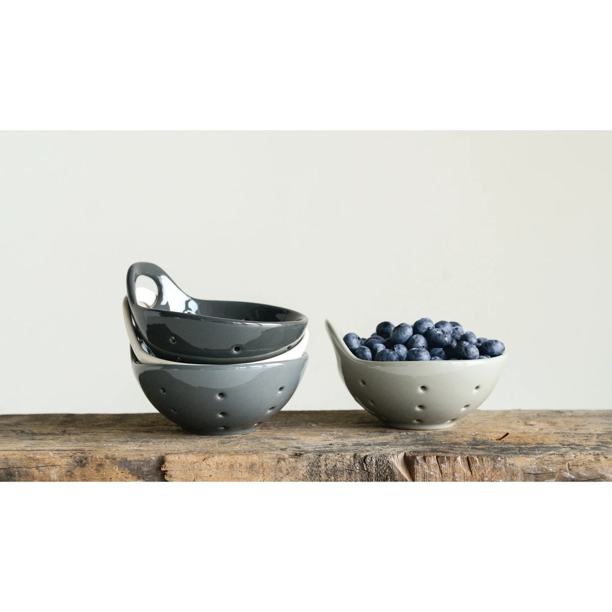 Ceramic colanders stacked with fresh blueberries in a stylish Stoneware Berry Bowl