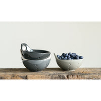 Ceramic colanders stacked with fresh blueberries in a stylish Stoneware Berry Bowl