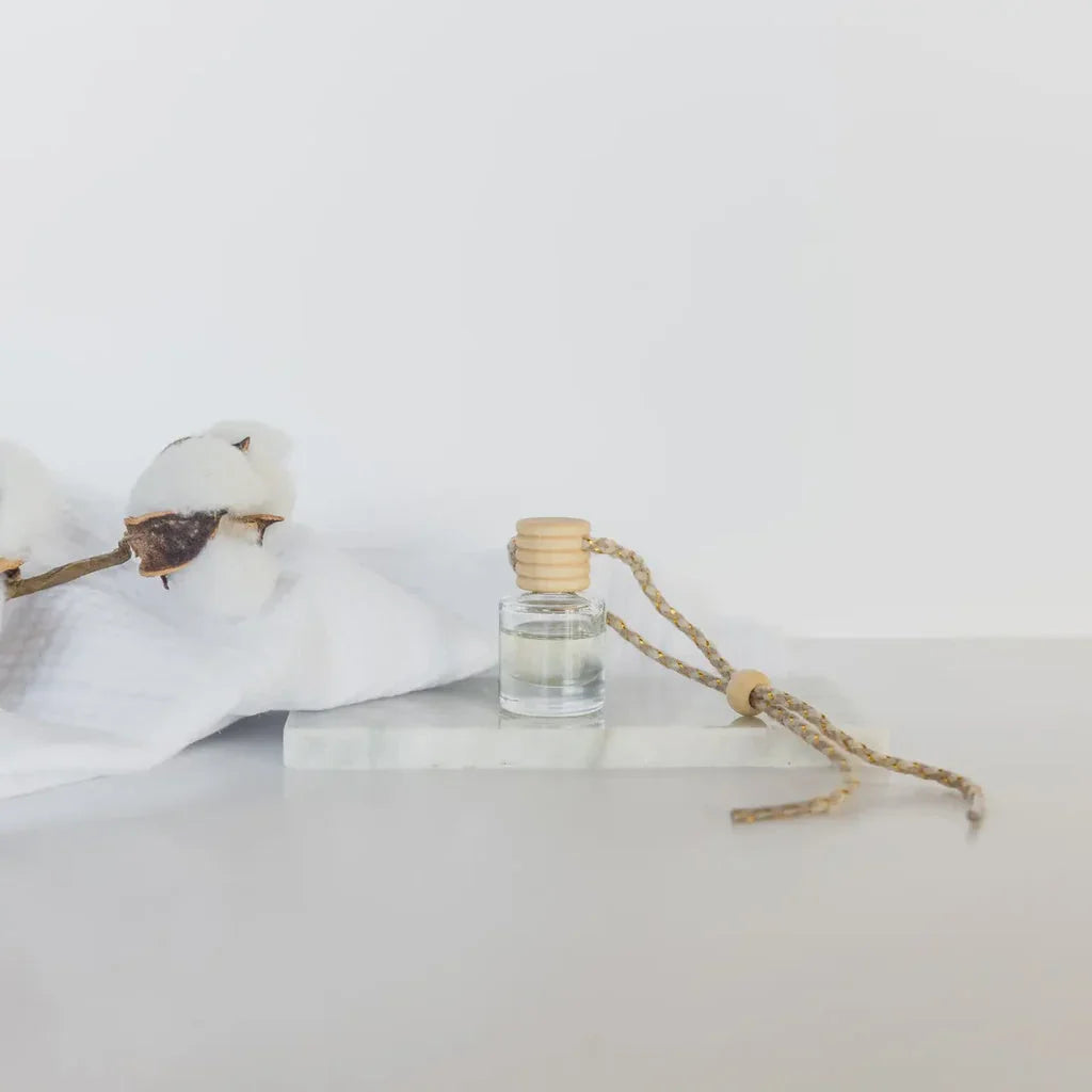 Clear glass car diffuser with wooden cap and woven string diffuser for women’s boho chic clothing