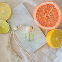 Clear glass essential oil bottle with wooden cap and braided string for car diffuser use