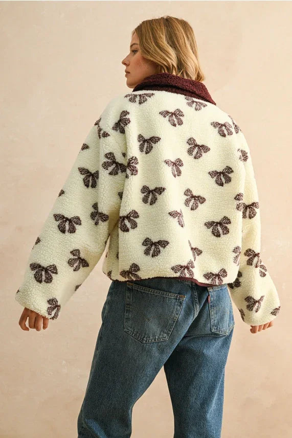 Cream-colored bow pattern sherpa jacket with maroon collar and button front