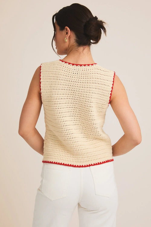 Cream-colored sleeveless button crochet top with red trim for stylish summer wear