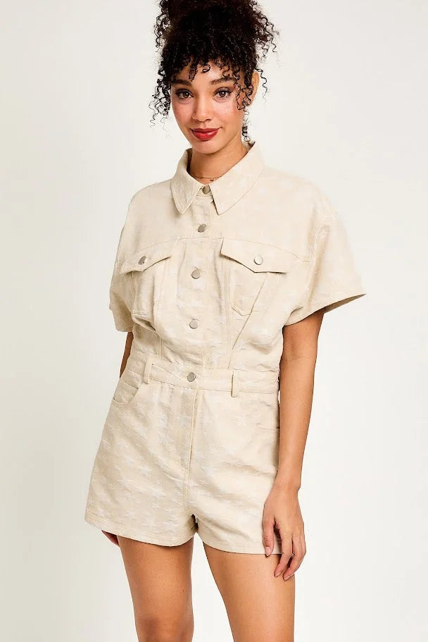 Cream-colored short-sleeved romper with utility pockets from Shop Daisy, ideal for women’s boho chic clothing