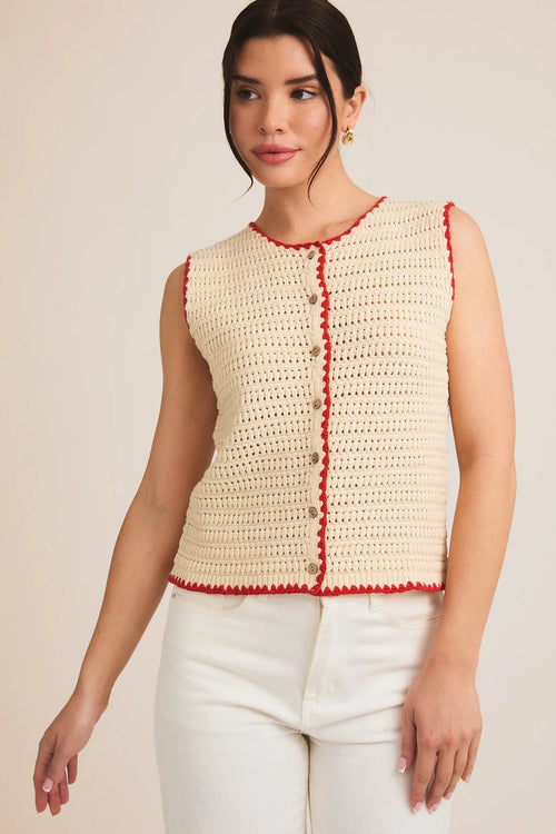 Cream-colored sleeveless crochet top with red trim and buttons, perfect for summer style
