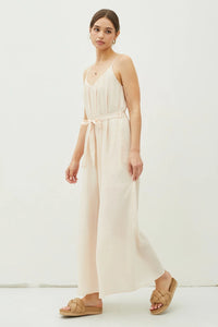 Cream-colored spaghetti strap jumpsuit with tie belt from Shop Daisy, perfect for women’s boho chic clothing