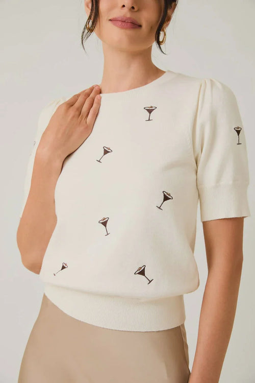 Cream-colored puff sleeve embroidered knit top with black cocktail glass embroidery