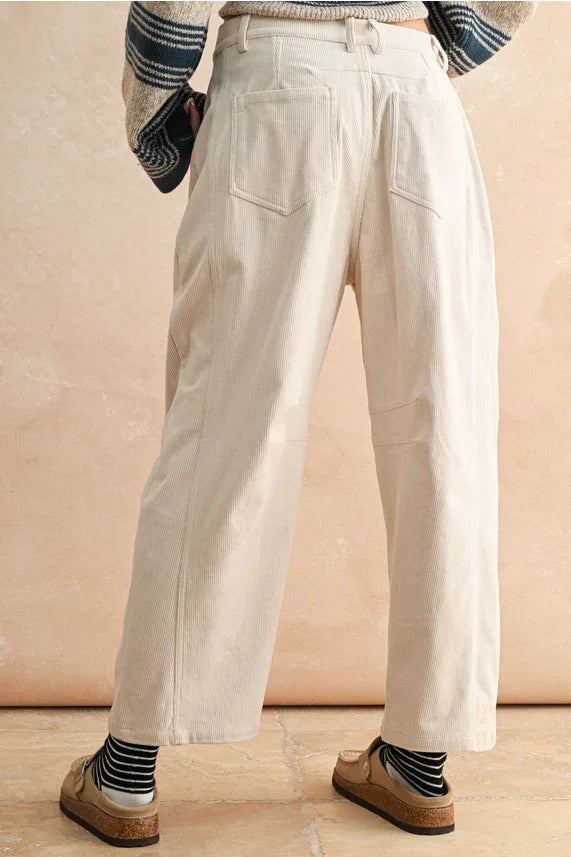 Cream-colored corduroy barrel pants with high waist and pockets, perfect for casual wear