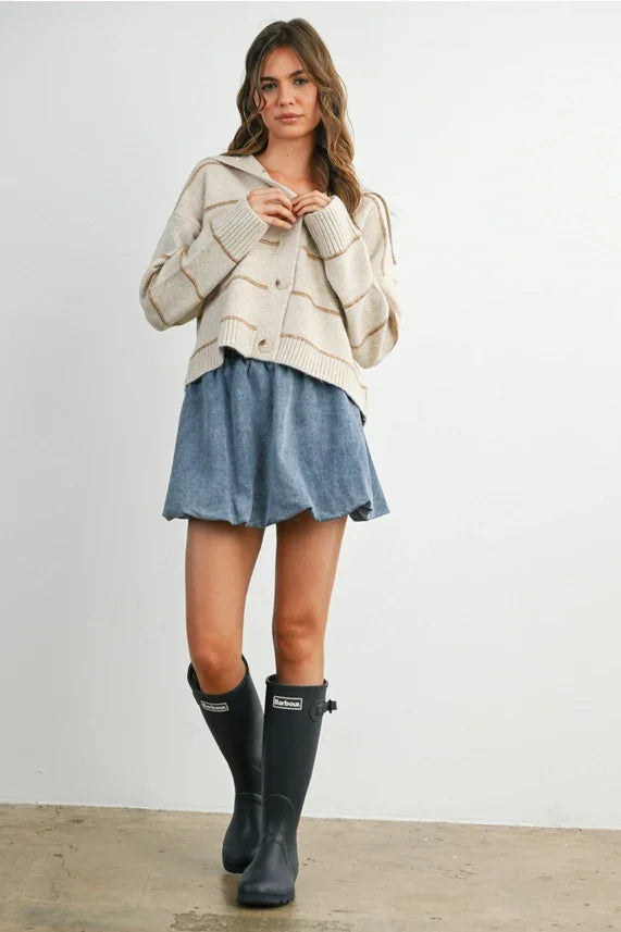 Cream textured striped collared cardigan with navy rain boots and denim skirt