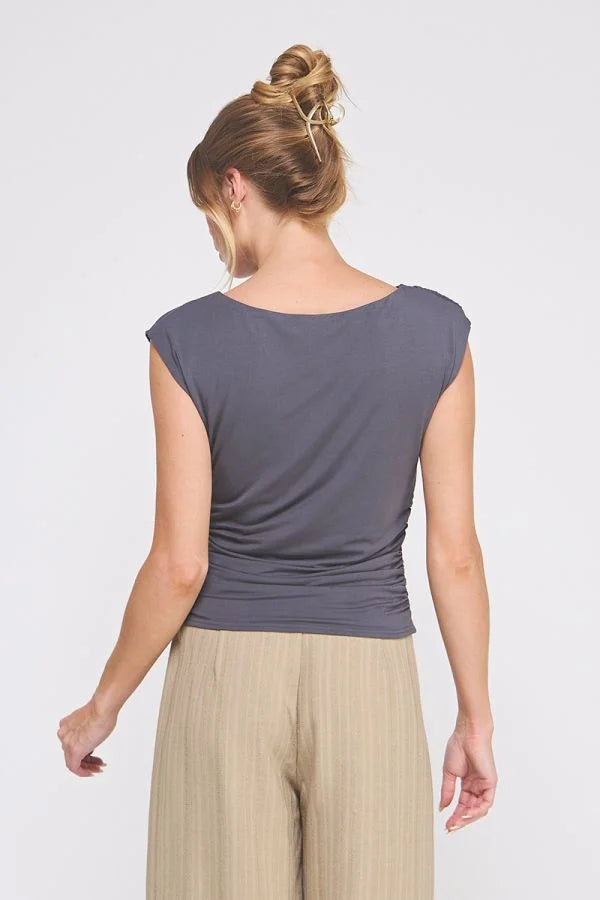 Dark gray sleeveless boat neck scrunch tank top with cap sleeves and beige wide-leg pants