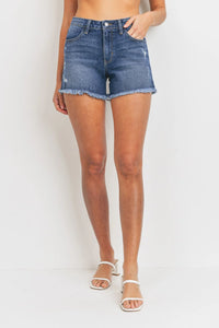 Mid rise distressed denim shorts with mini distress fray and frayed hem detail