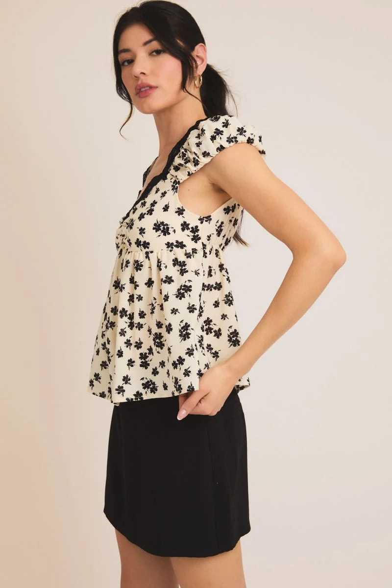 Floral print blouse with black trim from LACE TRIM BUBBLE SHORT SLEEVE TOP, perfect for women’s boho chic clothing