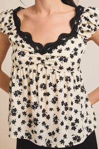 Floral print top with lace trim, perfect for women’s boho chic clothing from Shop Daisy
