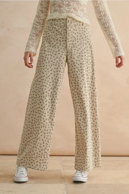Flowy beige floral printed corduroy pants with wide-leg design for a stylish look