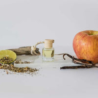 Car diffuser with light yellow liquid in a glass bottle, perfect for women’s boho chic clothing from Shop Daisy