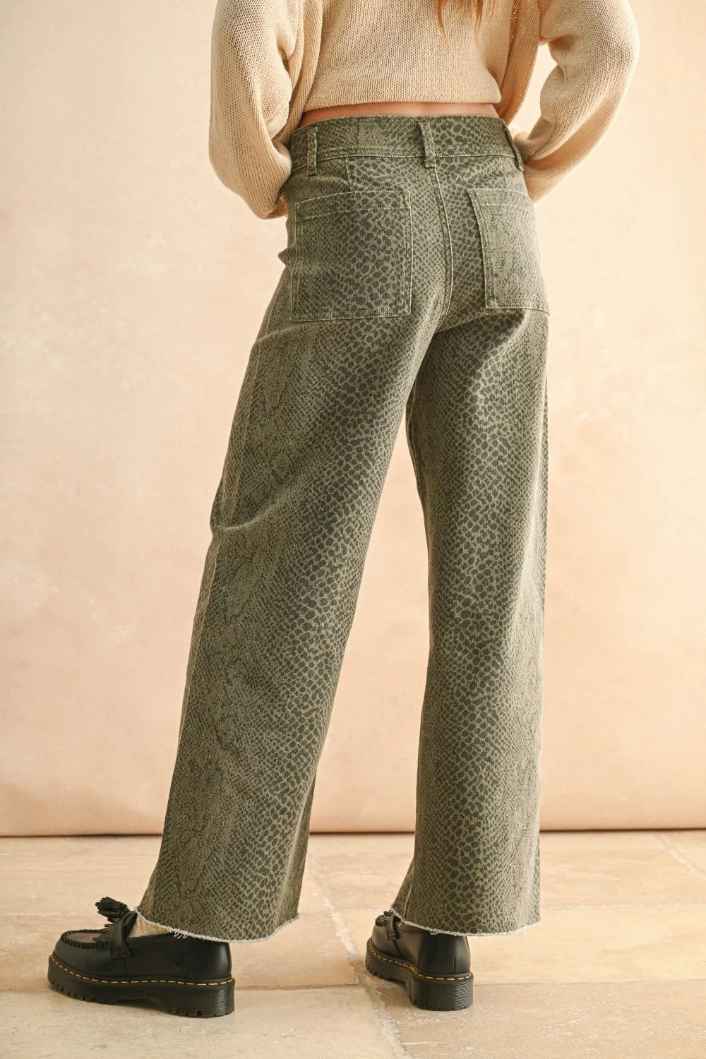 Green snakeskin pants for women featuring wide-leg silhouette and trendy snake print design
