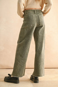 Green snakeskin pants for women featuring wide-leg silhouette and trendy snake print design