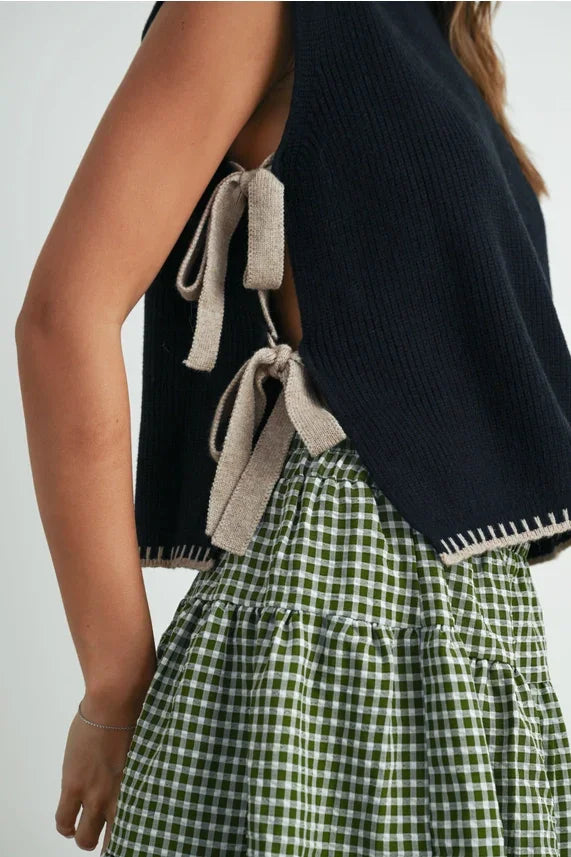 Mock neck sleeveless sweater with green white checkered skirt