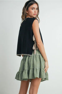 Mock neck sleeveless sweater with green and white gingham ruffled mini skirt and black trim