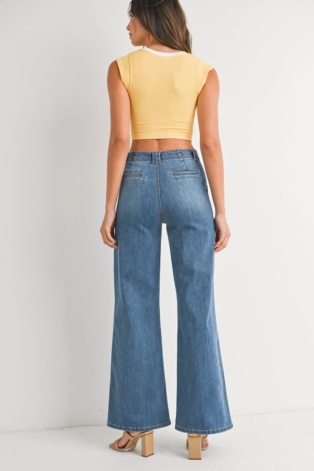 High-waisted patch pocket wide leg flare denim jeans with a cropped yellow ribbed top