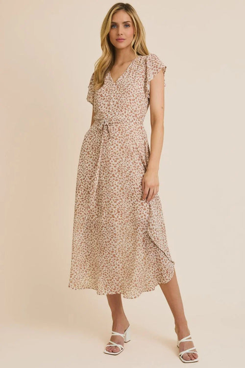 Knee-length light-colored animal print midi dress with short sleeves and tie waist