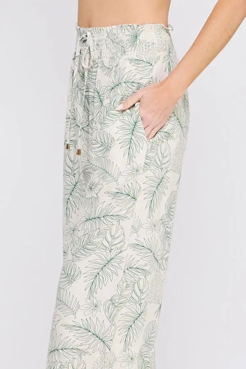 Leaf-patterned drawstring pants with smocked tie waist and wide leg silhouette