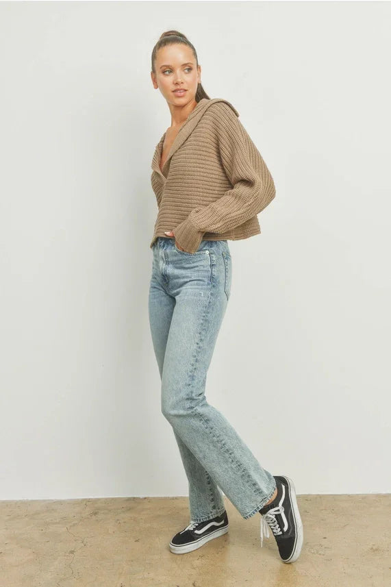 Drama collar V neck sweater with light blue distressed denim jeans and black Vans sneakers