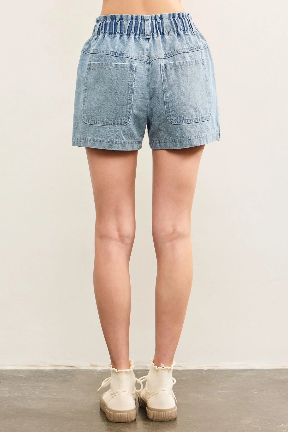 Light blue denim shorts from Pouch Pocket Denim Shorts, perfect for women’s boho chic clothing at Shop Daisy
