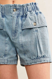 Light blue denim shorts with elastic waist and buttoned pockets for women’s boho chic clothing