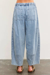 Light blue denim balloon pants featuring tied front and side seam detail for women’s boho chic clothing