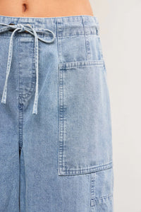 Light blue denim cargo pants from TIED FRONT SIDE SEAM DETAIL BALANCED BACK DENIM BALLOON PANTS, ideal for women’s boho chic clothing from Shop Daisy