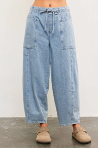 Light blue denim drawstring balloon pants from TIED FRONT SIDE SEAM DETAIL BANDED BACK collection, perfect for women’s boho chic clothing at Shop Daisy