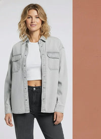 Light gray denim supply etta shirt over white crop top and dark gray jeans