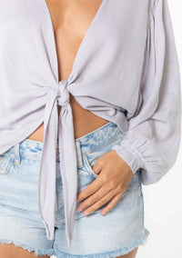 Light purple jacquard stripe long sleeve crop top with tie-front design and light-wash denim shorts