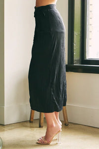 Long black pleated maxi skirt with high-heeled sandals from Shop Daisy, ideal for women’s boho chic clothing