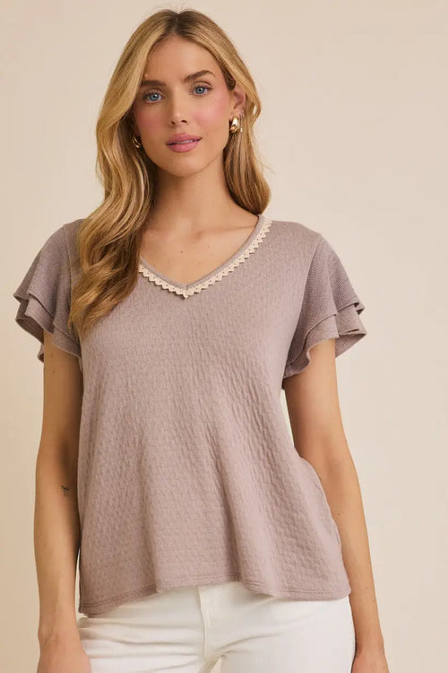 Mauve textured top with ruffle sleeves and elegant v-neck lace trim detail